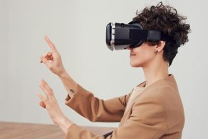 A woman engaging with virtual reality technology using a VR headset for an immersive experience.